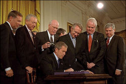 President George W. Bush signing the USA PATRIOT ACT in the White House's East Room on October 26, 2001.